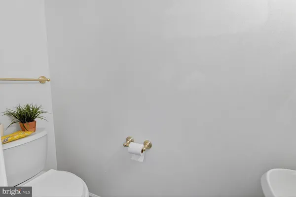 a white toilet sitting next to a shower