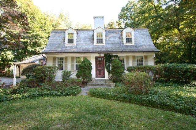 261 Old Academy Road Fairfield, CT 06824 - Photo 1 of 1 a front view of a house with garden