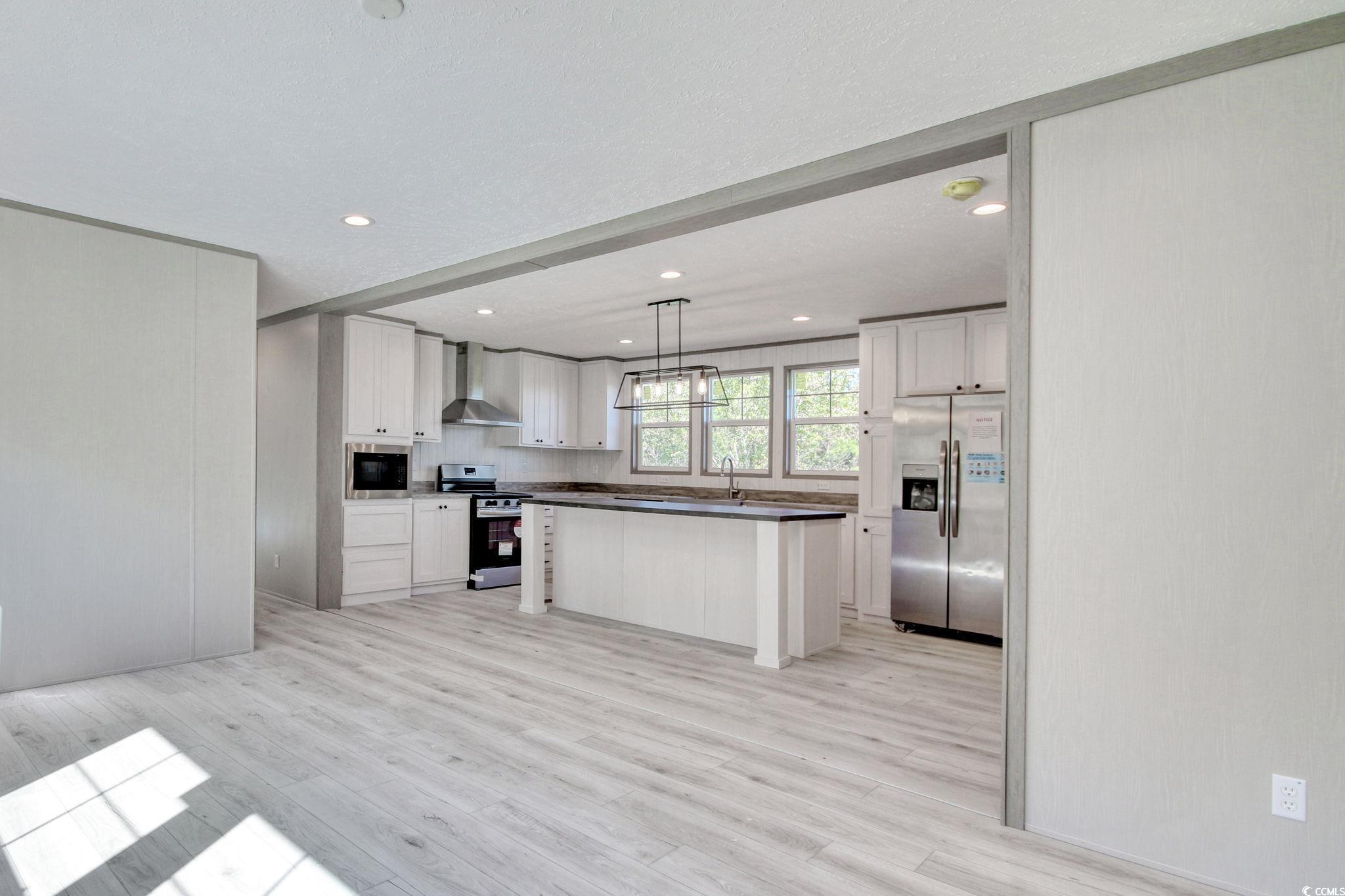 280 Samuel Road Loris, SC 29569 - Photo 11 of 29 Kitchen featuring a kitchen island, wall chimney r