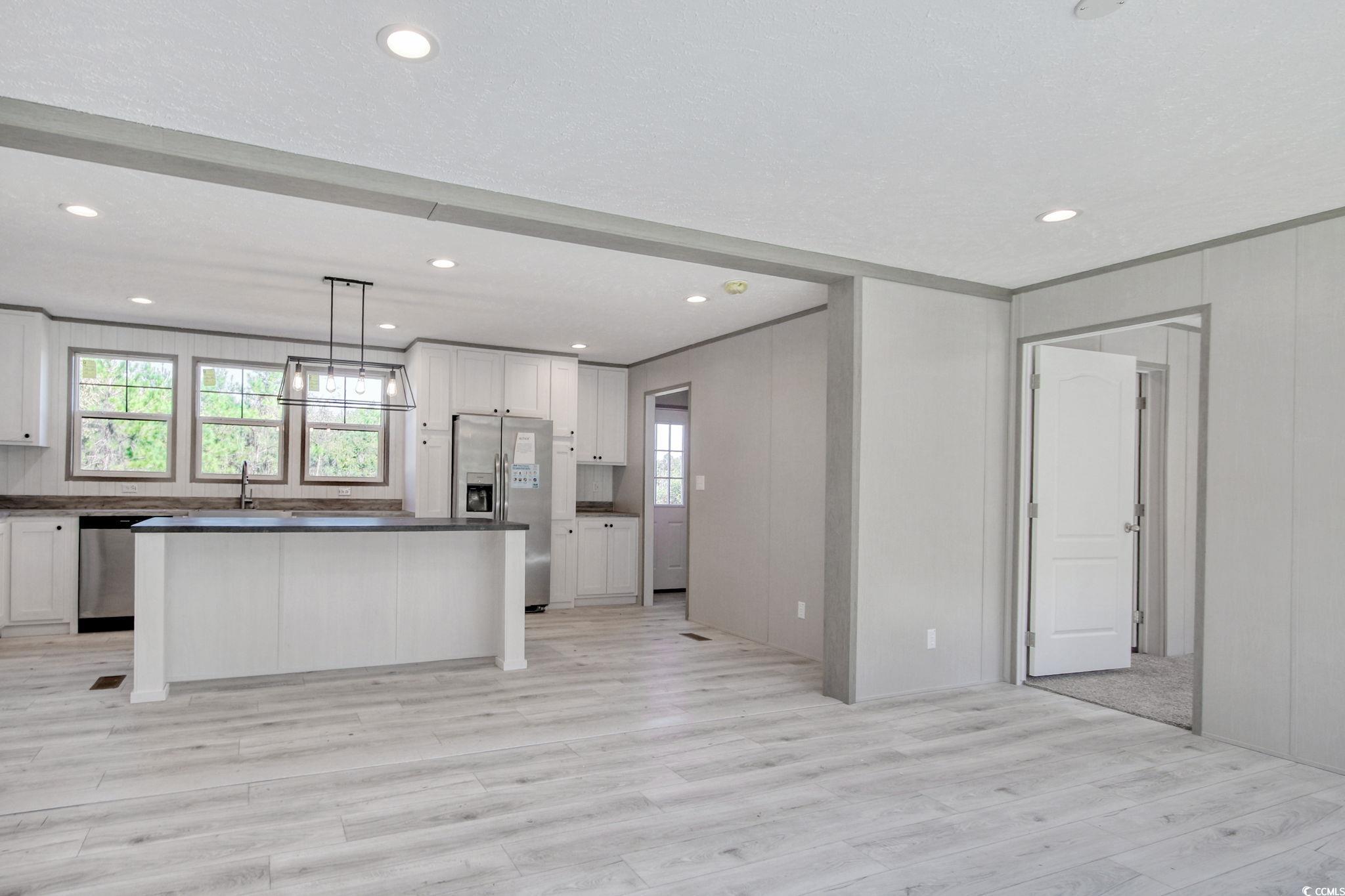 280 Samuel Road Loris, SC 29569 - Photo 12 of 29 Kitchen featuring white cabinets, a kitchen island