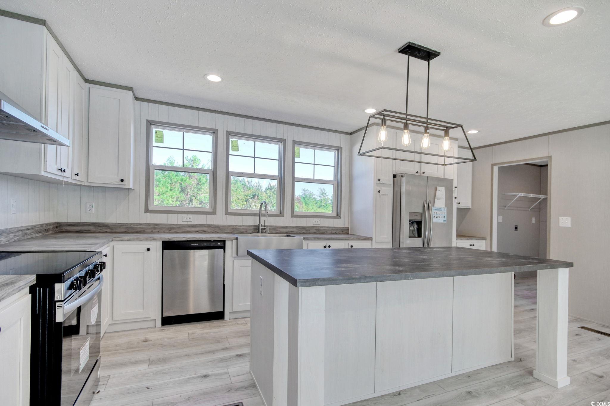 280 Samuel Road Loris, SC 29569 - Photo 7 of 29 Kitchen featuring white cabinets, a textured ceili