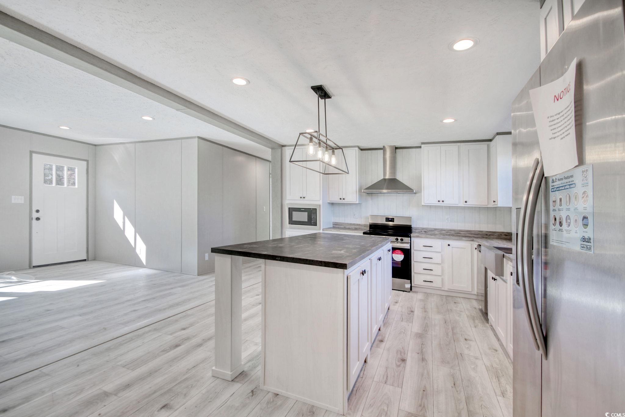 280 Samuel Road Loris, SC 29569 - Photo 9 of 29 Kitchen with wall chimney range hood, appliances w