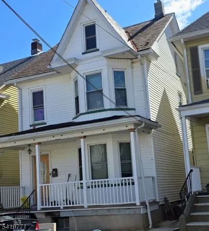 a view of a white house with large windows