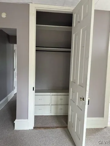 a view of walk in closet with empty racks