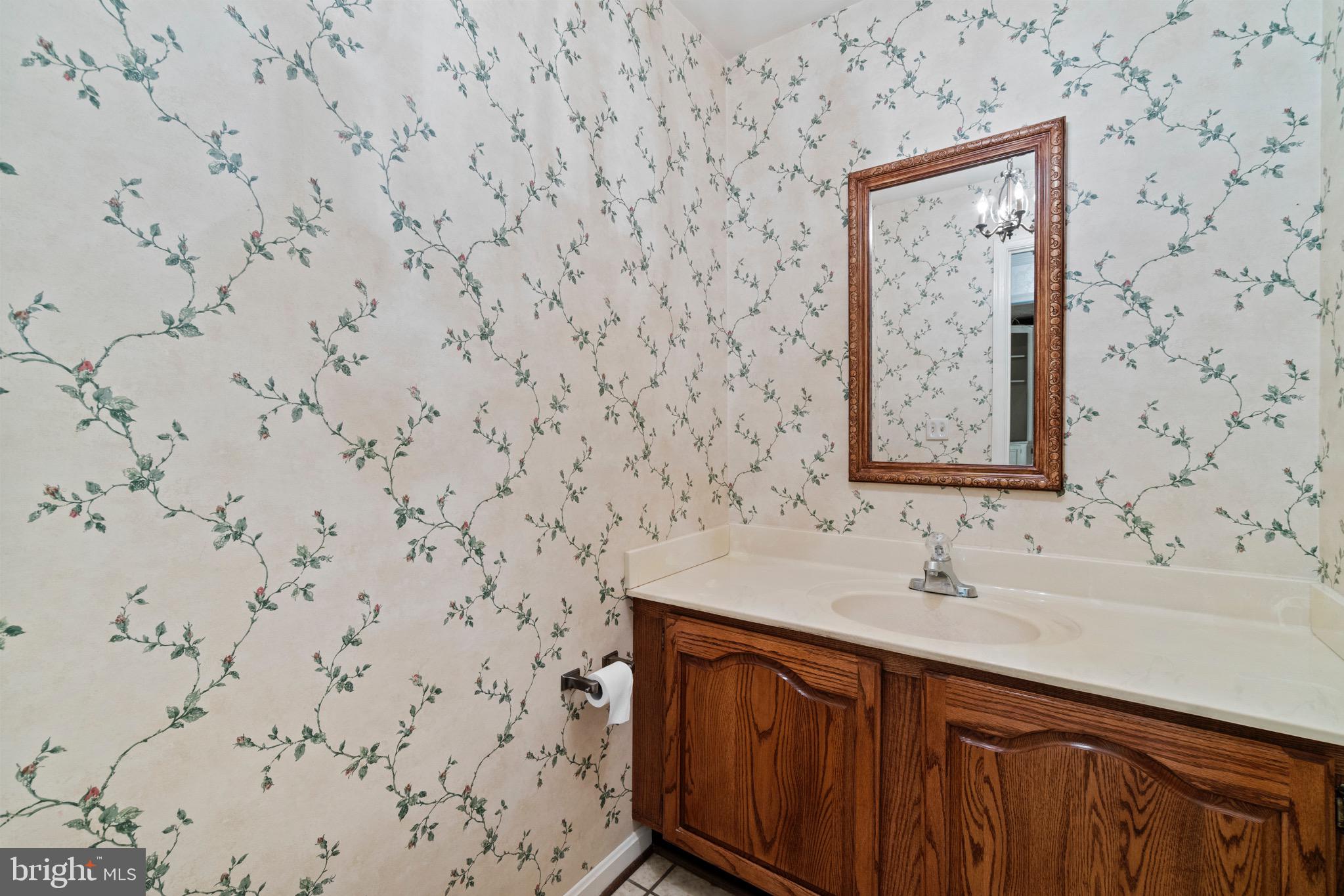 7409 Warfield Road Gaithersburg, MD 20882 - Photo 12 of 22 a bathroom with a sink and a mirror