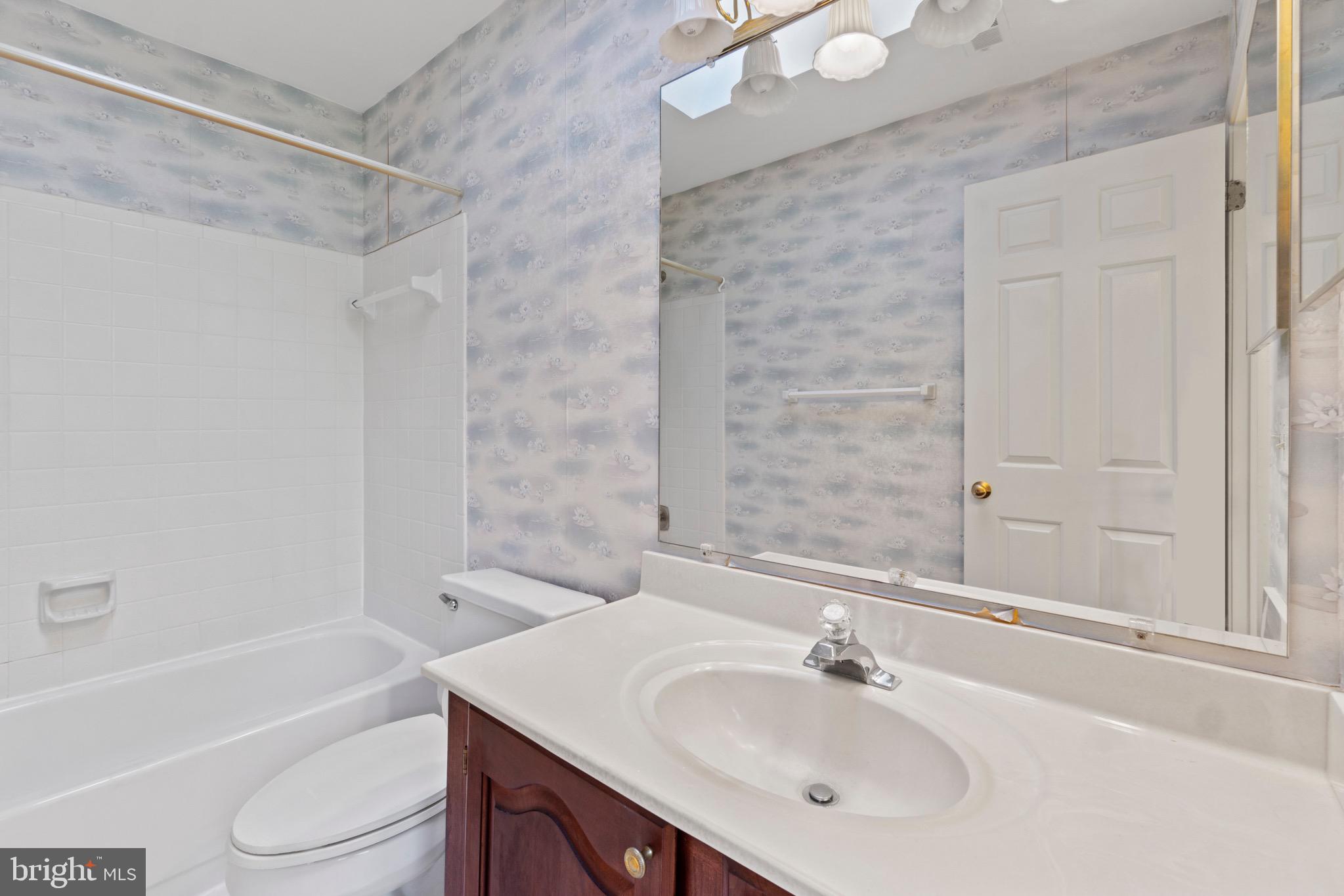 7409 Warfield Road Gaithersburg, MD 20882 - Photo 16 of 22 a bathroom with a sink toilet and shower