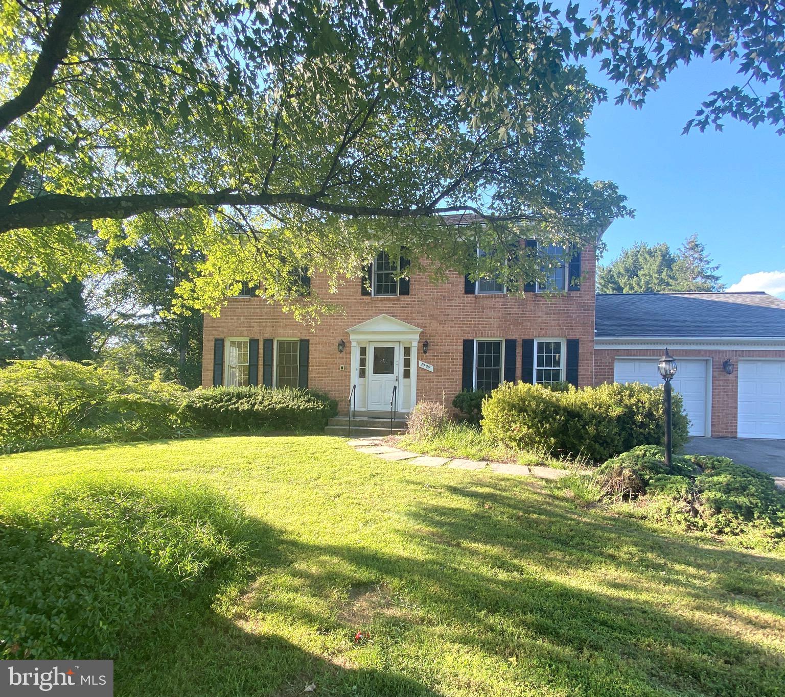 7409 Warfield Road Gaithersburg, MD 20882 - Photo 2 of 22 a front view of a house with a yard