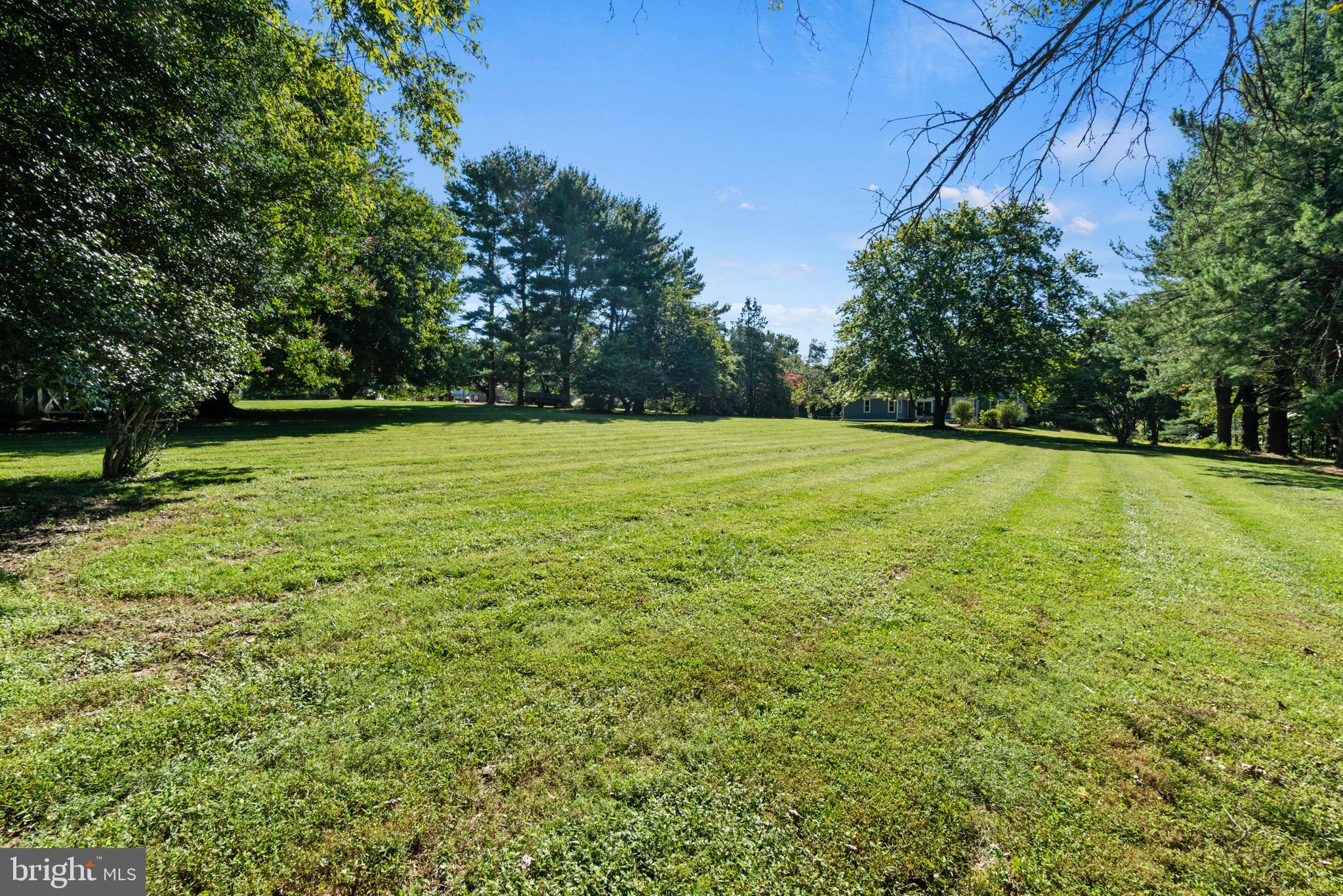 7409 Warfield Road Gaithersburg, MD 20882 - Photo 21 of 22 a view of a field with a trees in the background