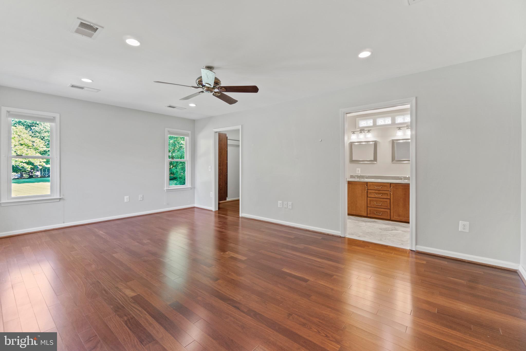 7409 Warfield Road Gaithersburg, MD 20882 - Photo 5 of 22 a view of an empty room with a window and wooden floor