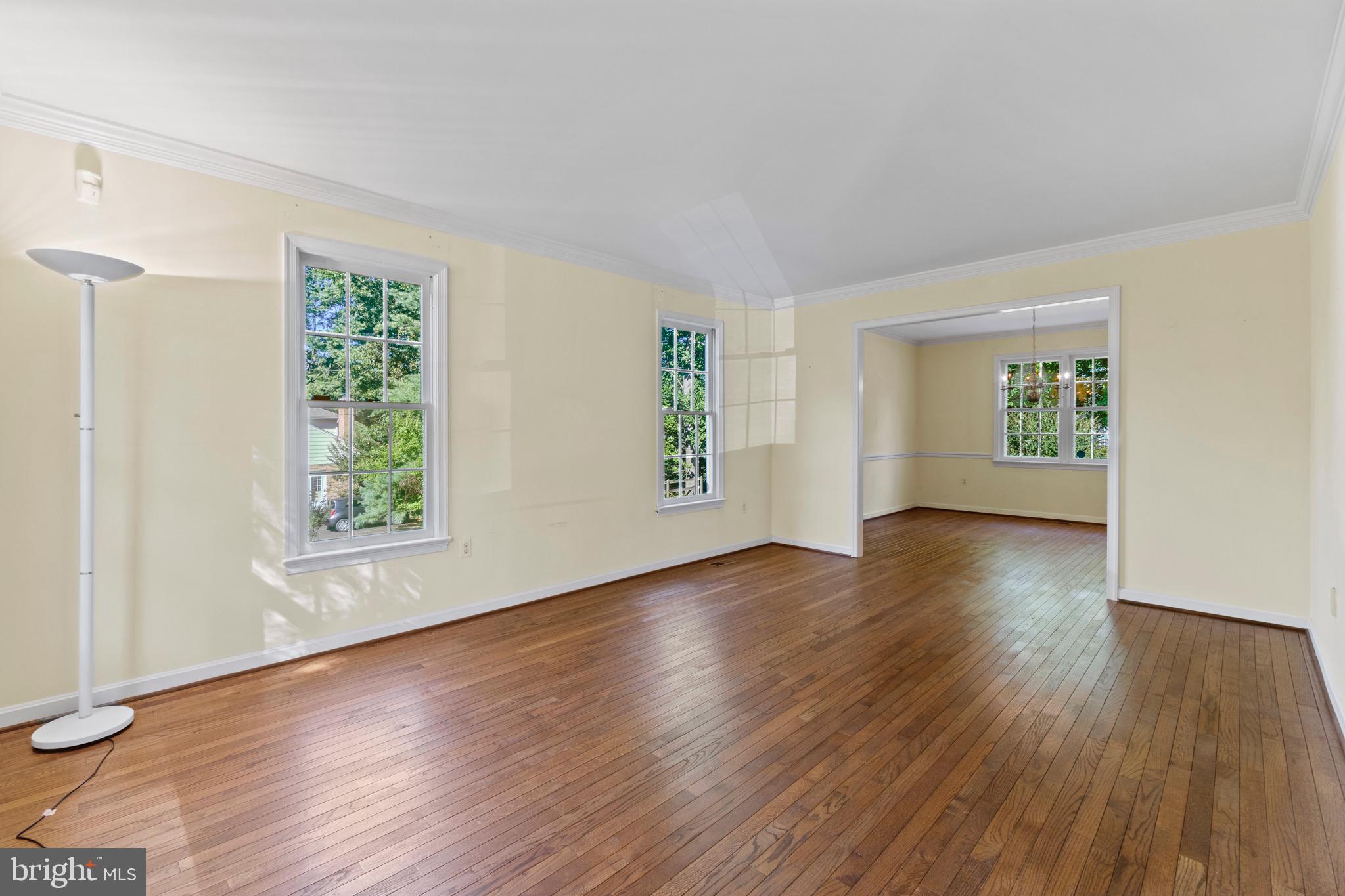 7409 Warfield Road Gaithersburg, MD 20882 - Photo 6 of 22 an empty room with wooden floor and windows