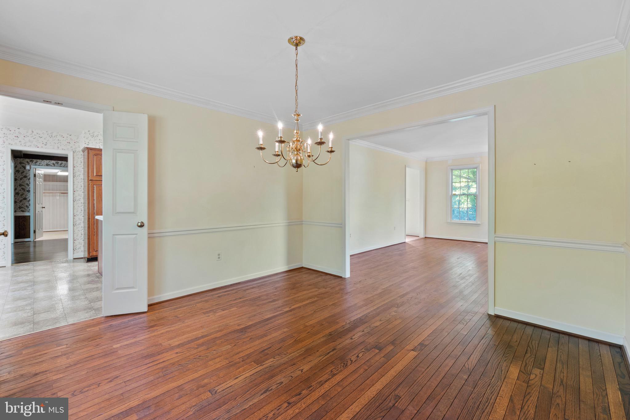7409 Warfield Road Gaithersburg, MD 20882 - Photo 8 of 22 a view of a room with wooden floor and chandelier