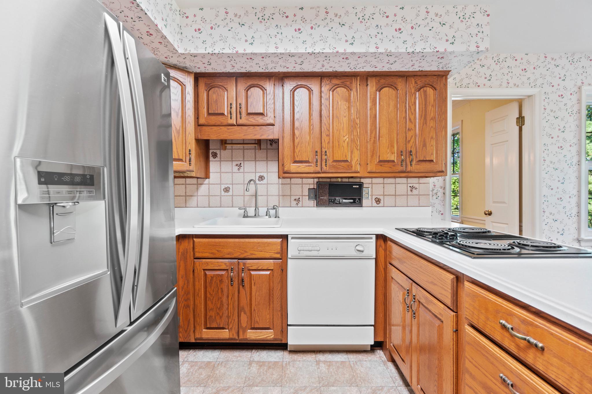 7409 Warfield Road Gaithersburg, MD 20882 - Photo 9 of 22 a kitchen with stainless steel appliances granite countertop a refrigerator and a stove