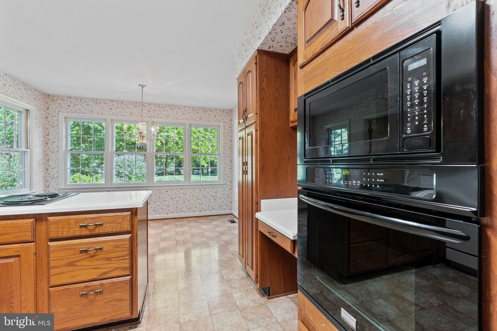 7409 Warfield Road Gaithersburg, MD 20882 - Photo 10 of 22 a kitchen with a stove and a microwave