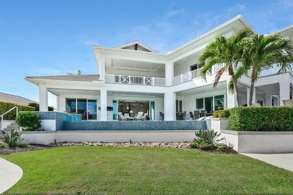 a view of a swimming pool with a lawn chairs and a fire pit