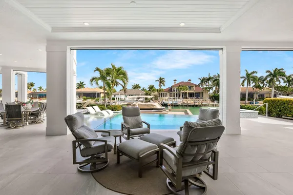 a view of a swimming pool with outdoor seating