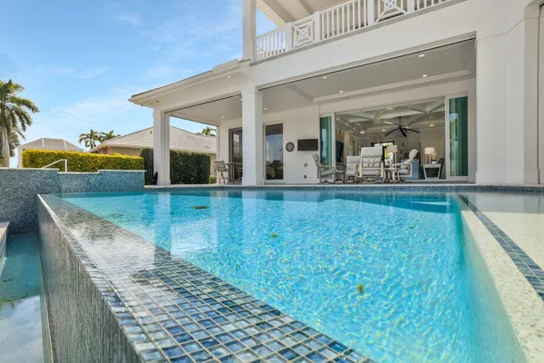 a view of swimming pool with a lounge chairs