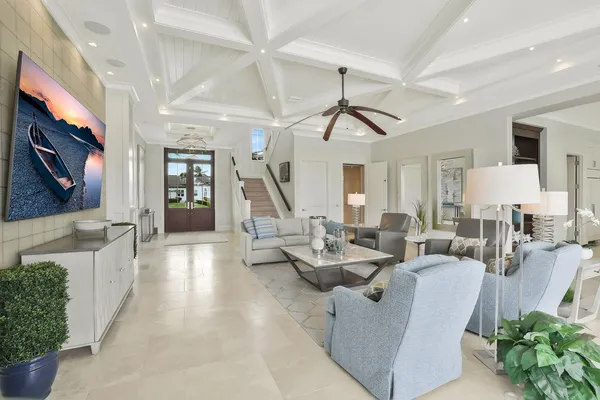 a living room with patio furniture and a flat screen tv