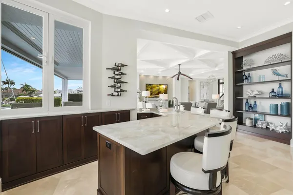 a kitchen with a table chairs and wooden floor