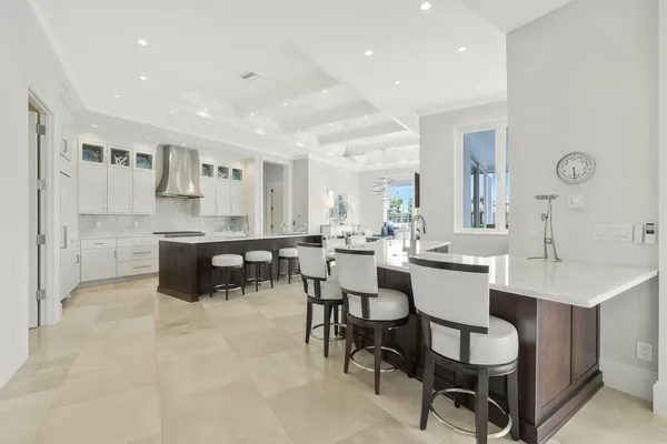 a kitchen with a dining table chairs and view living room