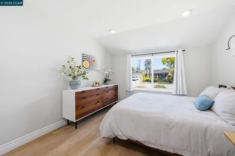 a workspace with a bed and a window