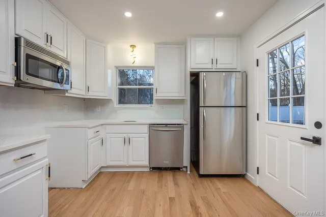 a kitchen with a refrigerator stove and microwave
