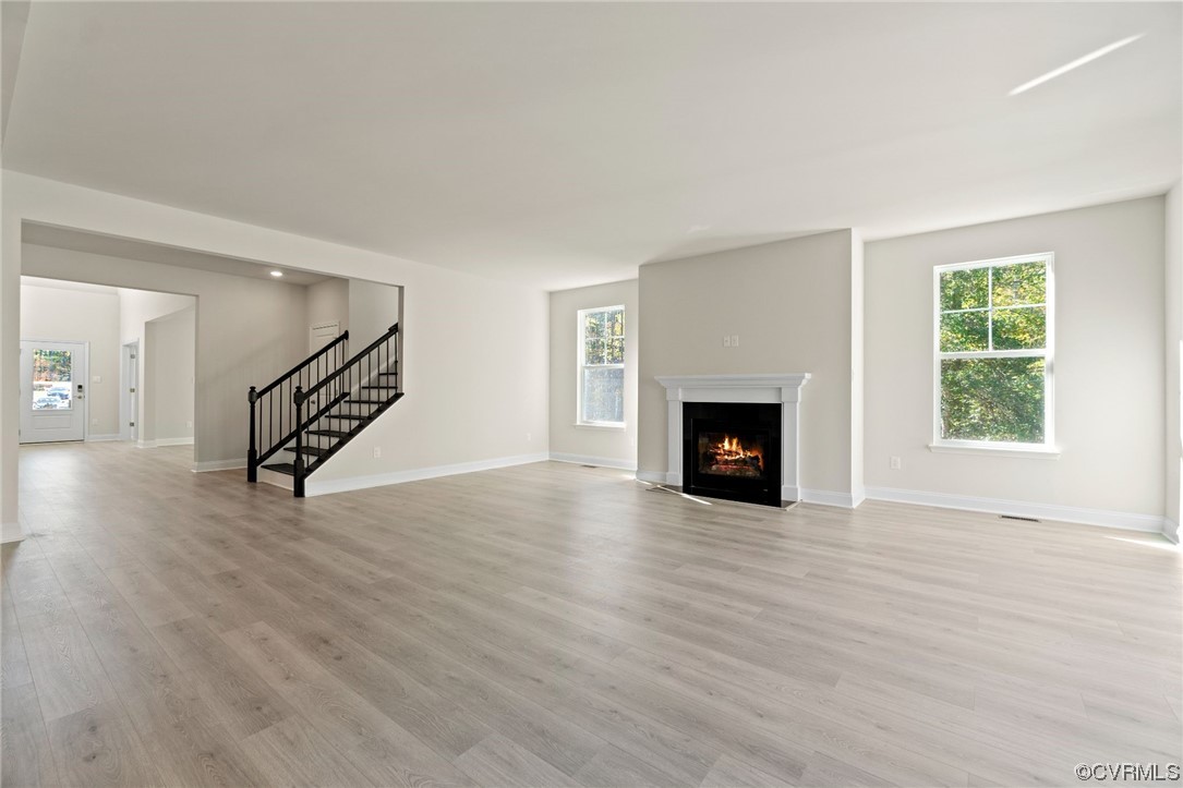 12812 Lonan Avenue Chesterfield, VA 23838 - Photo 12 of 49 a view of a livingroom with wooden floor and a fireplace