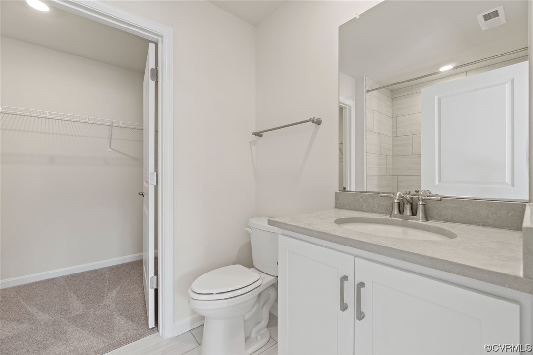 12812 Lonan Avenue Chesterfield, VA 23838 - Photo 29 of 49 a bathroom with a granite countertop sink a toilet and a mirror
