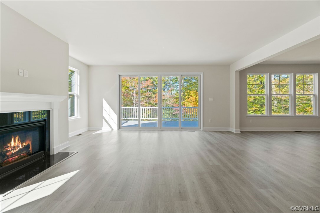 12812 Lonan Avenue Chesterfield, VA 23838 - Photo 46 of 49 a view of an empty room with wooden floor fireplace and a window
