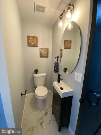 a bathroom with a toilet sink and mirror