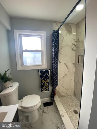 a bathroom with a toilet and shower