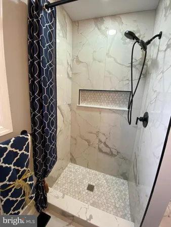 a bathroom with a bathtub and shower