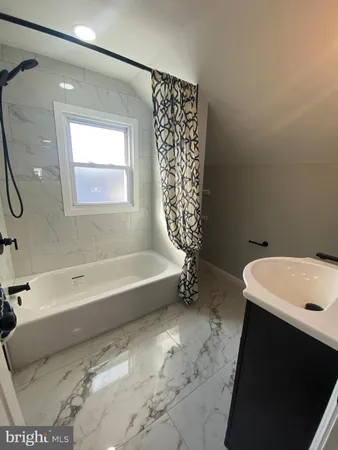 a bathroom with a sink a bathtub and a shower