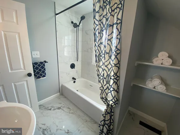 a bathroom with a bathtub and shower