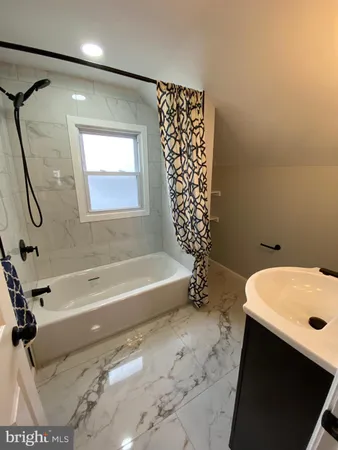a bathroom with a bathtub a sink and a shower