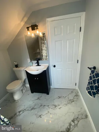 a bathroom with a sink toilet and vanity