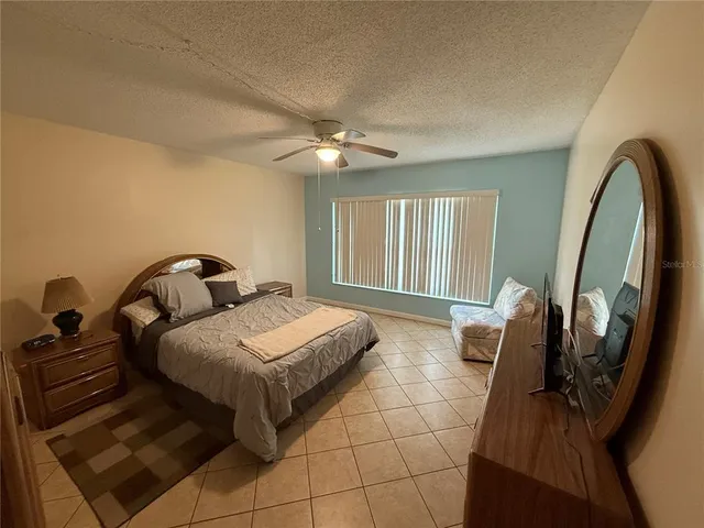 a bedroom with bed and a chandelier