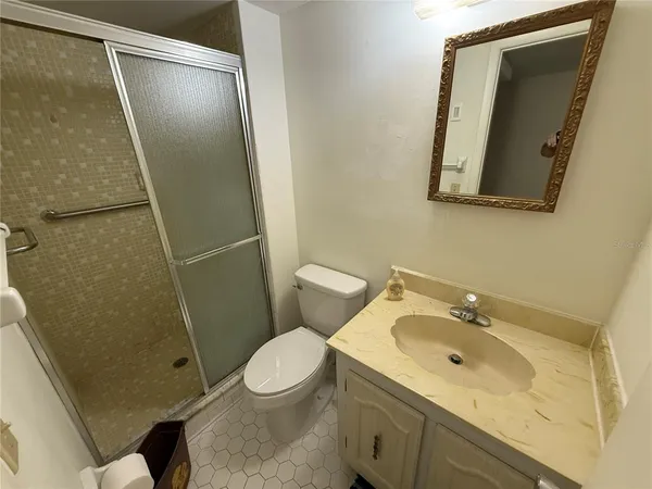 a bathroom with a sink and mirror with toilet