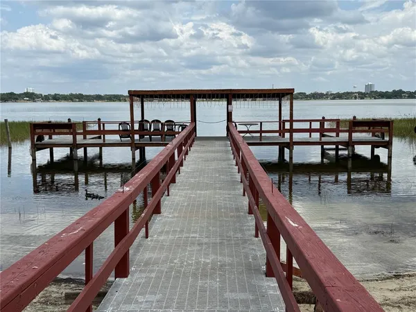 a balcony with view of dining room and furniture