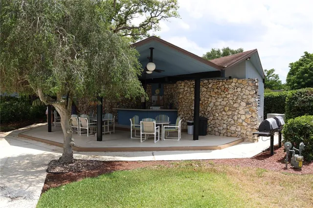 a view of a chair and table in backyard