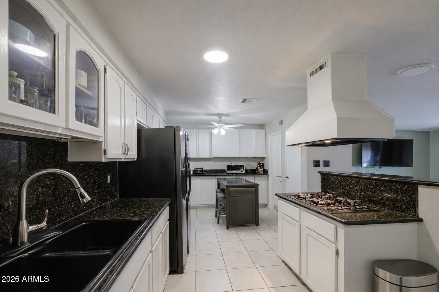 3107 West Montebello Avenue Phoenix, AZ 85017 - Photo 8 of 30 a kitchen with granite countertop stainless steel appliances a sink a stove cabinets and a window