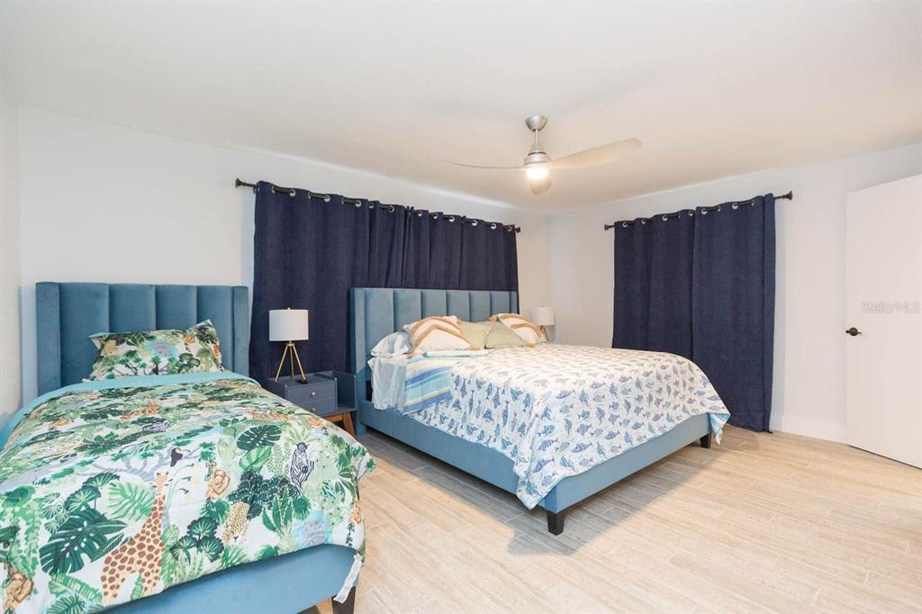 1613 Druid Road Clearwater, FL 33756 - Photo 14 of 47 a bedroom with two beds and a dresser