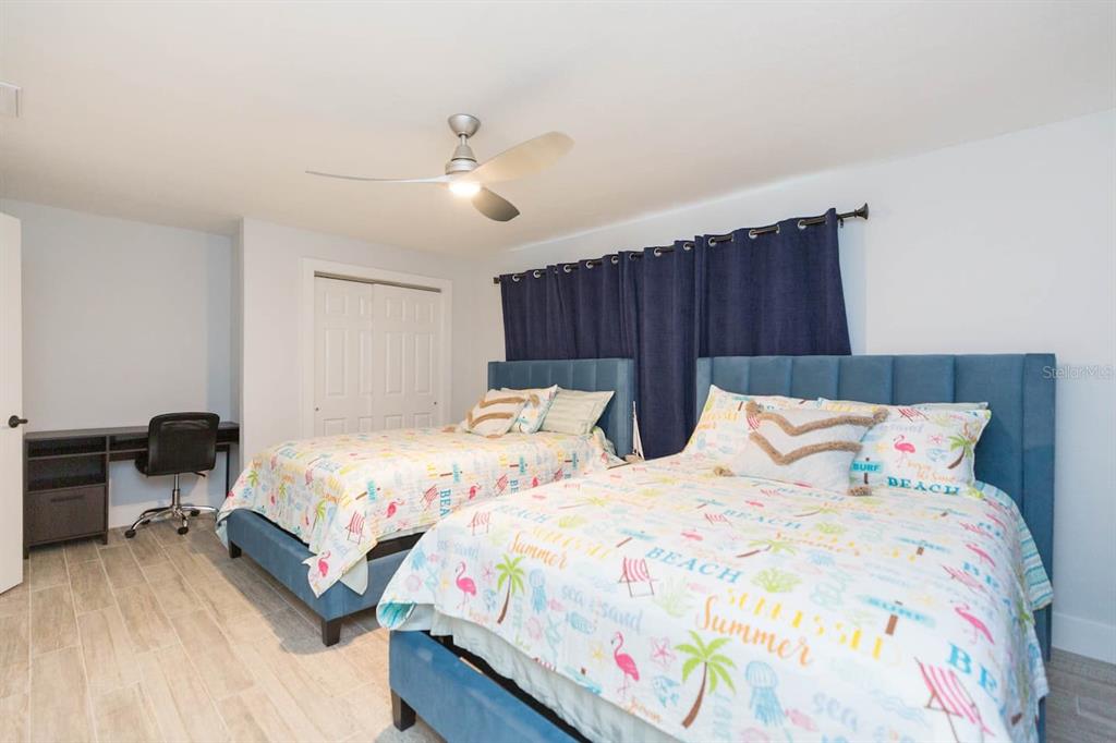 1613 Druid Road Clearwater, FL 33756 - Photo 19 of 47 a bedroom with bed and a chandelier