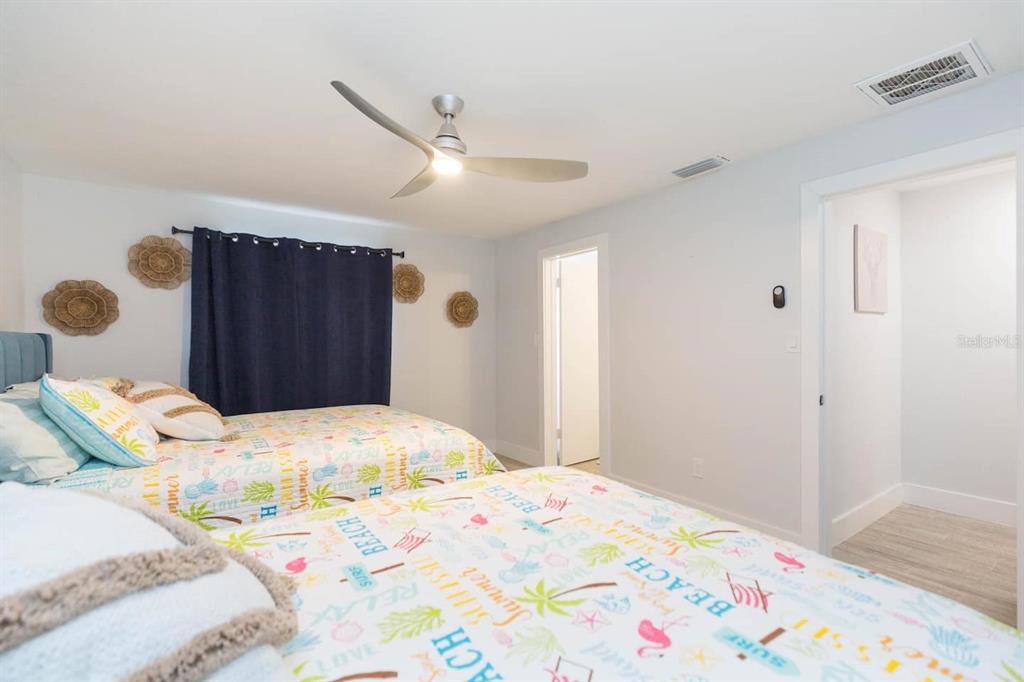 1613 Druid Road Clearwater, FL 33756 - Photo 21 of 47 a bedroom with a bed and a dresser