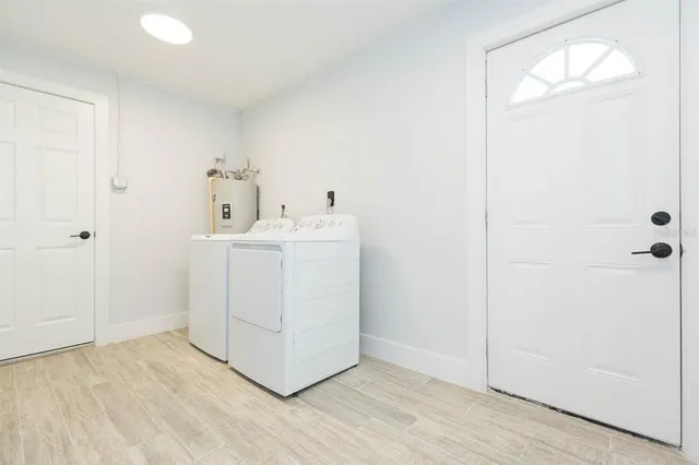a utility room with cabinets washer and dryer