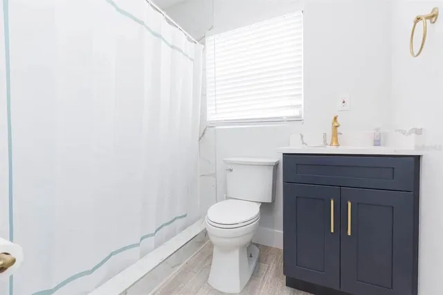 a bathroom with a toilet sink and a window