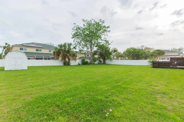 a view of yard with swimming pool and green space
