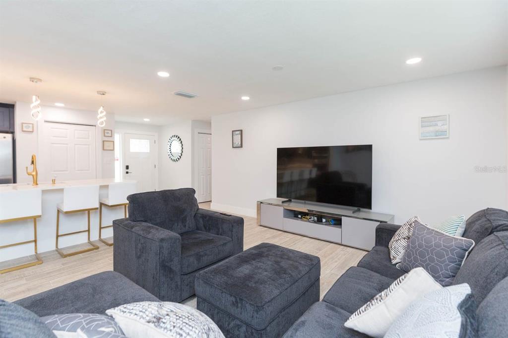 1613 Druid Road Clearwater, FL 33756 - Photo 6 of 47 a living room with furniture and a flat screen tv