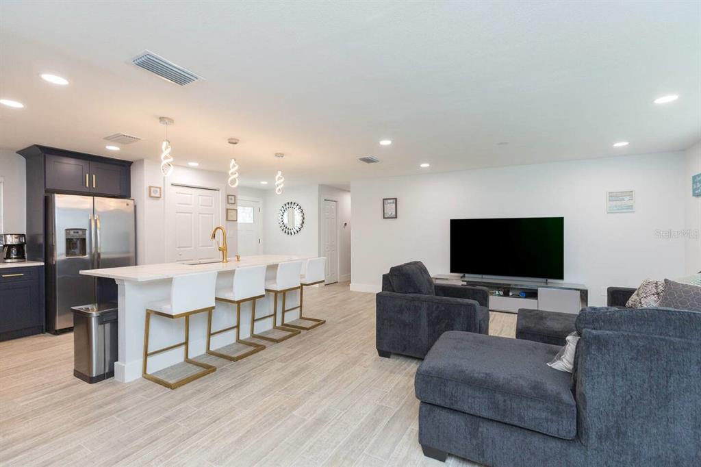 1613 Druid Road Clearwater, FL 33756 - Photo 7 of 47 a living room with furniture and a flat screen tv