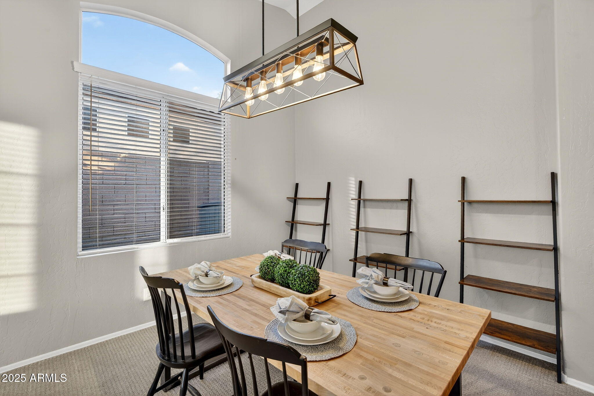 15427 South 16th Avenue Phoenix, AZ 85045 - Photo 16 of 53 a view of a dining room with furniture and a chandelier
