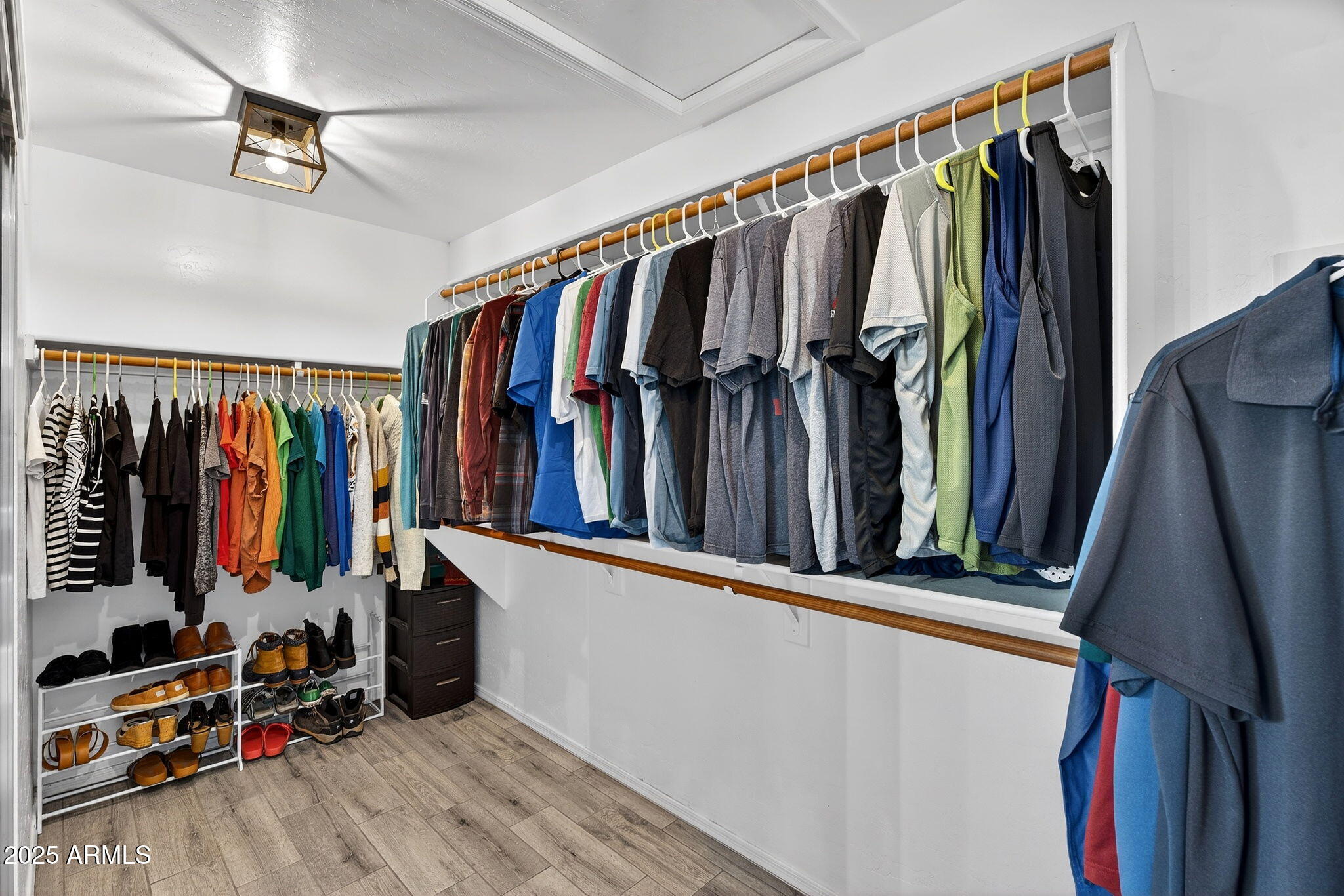 15427 South 16th Avenue Phoenix, AZ 85045 - Photo 26 of 53 a view of walk in closet with clothes and shoes